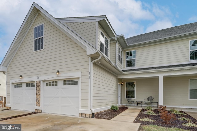 view of front of house with covered porch and a garage