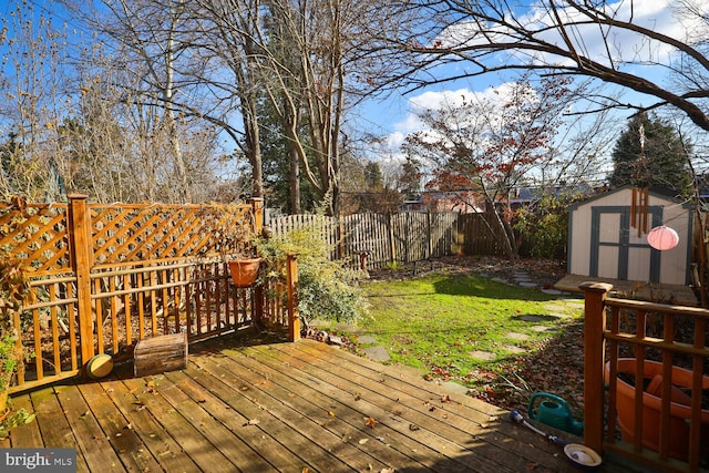 deck featuring a yard and a storage unit