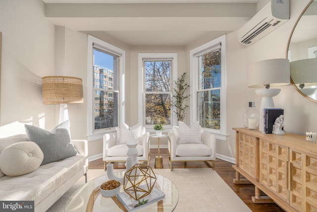 sitting room featuring hardwood / wood-style floors and a wall mounted AC