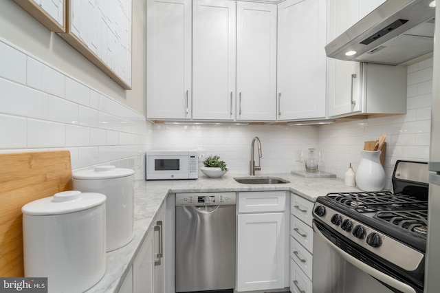 kitchen featuring sink, white cabinets, extractor fan, and stainless steel appliances