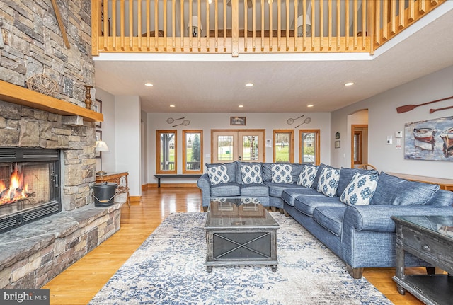 living room with a fireplace, hardwood / wood-style floors, and a textured ceiling