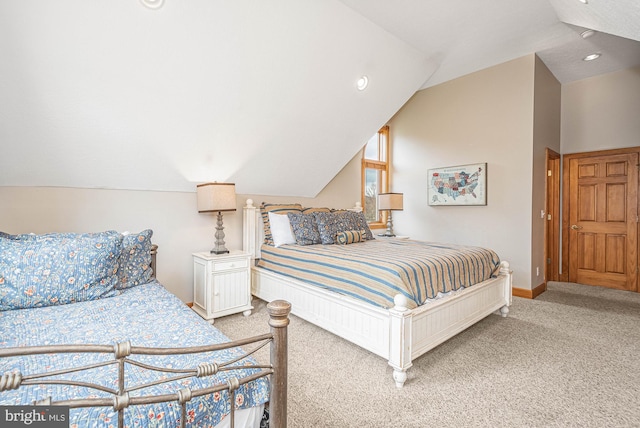 carpeted bedroom with lofted ceiling