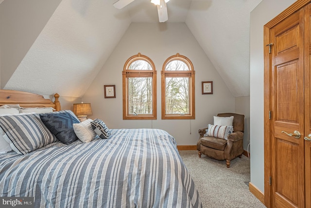 bedroom with ceiling fan, carpet floors, and lofted ceiling