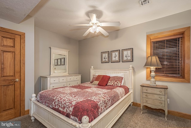 carpeted bedroom with a textured ceiling and ceiling fan