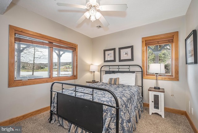 bedroom featuring ceiling fan and light colored carpet