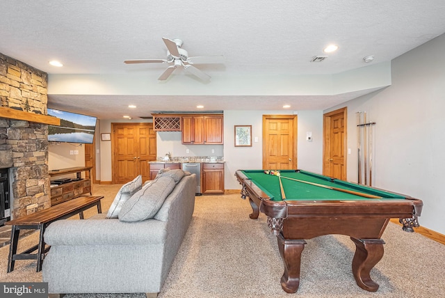 game room featuring light carpet, a textured ceiling, ceiling fan, and pool table