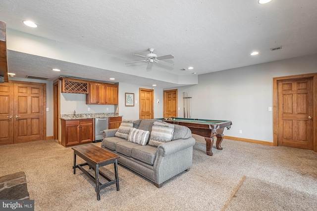 carpeted living room with ceiling fan, a textured ceiling, billiards, and indoor bar