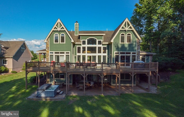 back of house with a yard, area for grilling, a patio area, and a wooden deck