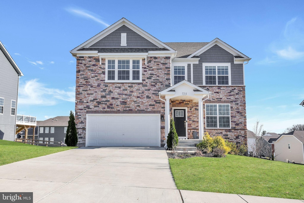 view of front of property with a garage and a front lawn