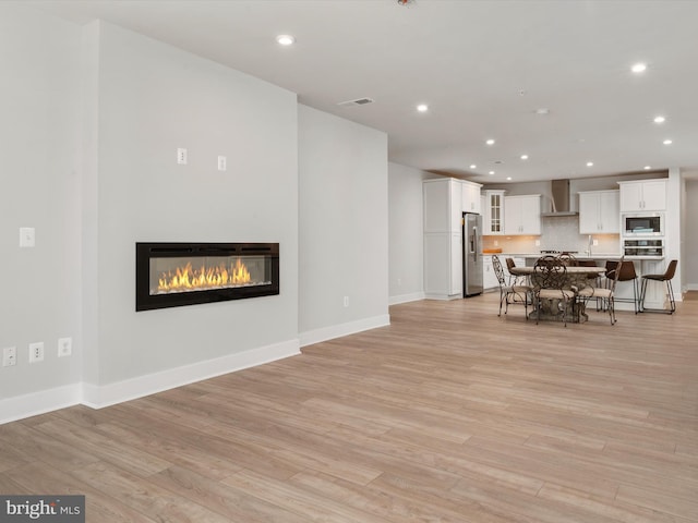 dining room featuring light wood-style flooring, visible vents, and recessed lighting