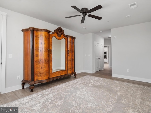 unfurnished living room with ceiling fan and hardwood / wood-style floors