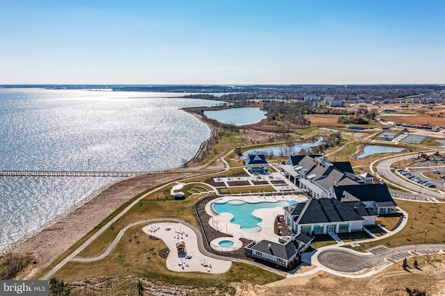 birds eye view of property with a view of the beach and a water view