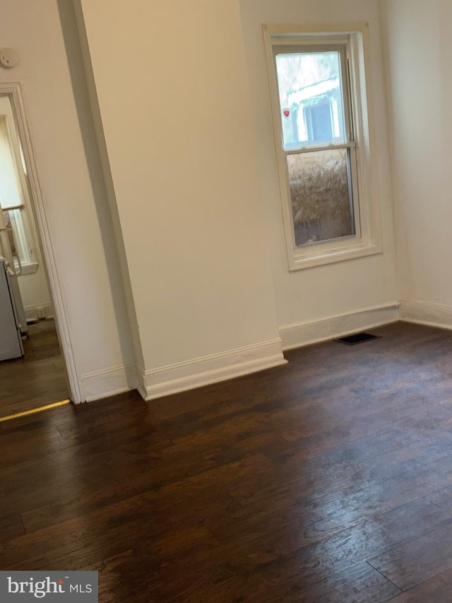 unfurnished room featuring dark hardwood / wood-style floors