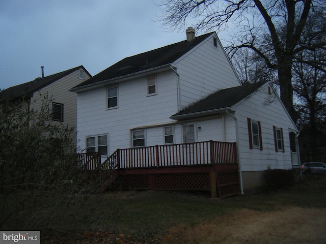 back of house featuring a deck