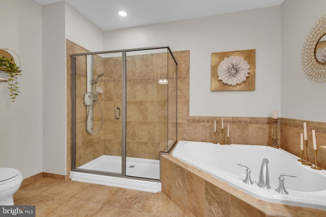 bathroom with tile patterned flooring, toilet, and shower with separate bathtub