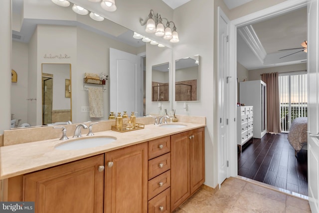 bathroom featuring ceiling fan, hardwood / wood-style floors, and vanity