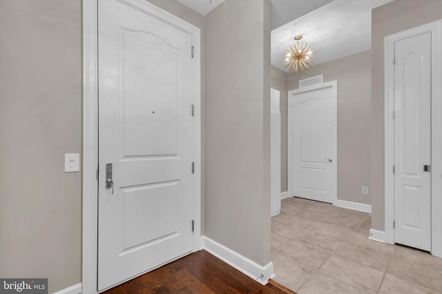 foyer featuring an inviting chandelier and light hardwood / wood-style flooring