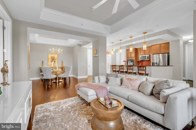 1915 Towne Centre Blvd Unit 416, Annapolis, MD 21401 - living room featuring a tray ceiling, hardwood / wood-style floors, a chandelier, ceiling fan, and ornamental molding