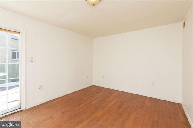 unfurnished room with hardwood / wood-style floors