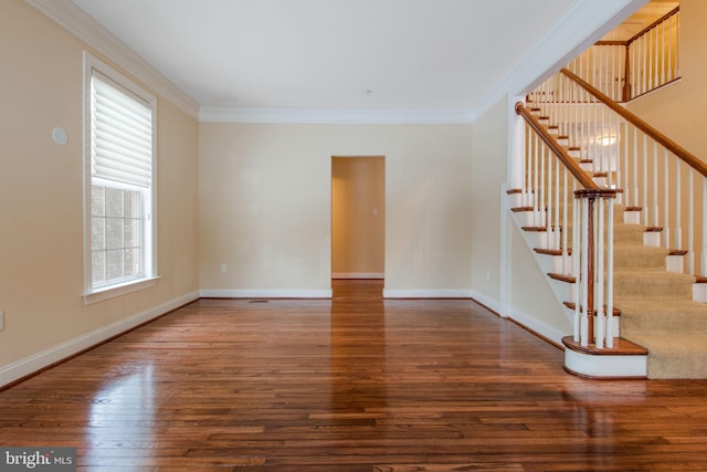 unfurnished living room featuring ornamental molding, a healthy amount of sunlight, and dark hardwood / wood-style floors