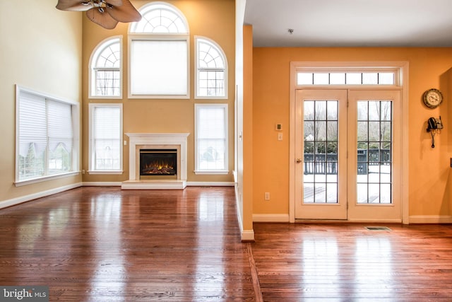 unfurnished living room featuring a wealth of natural light and wood-type flooring