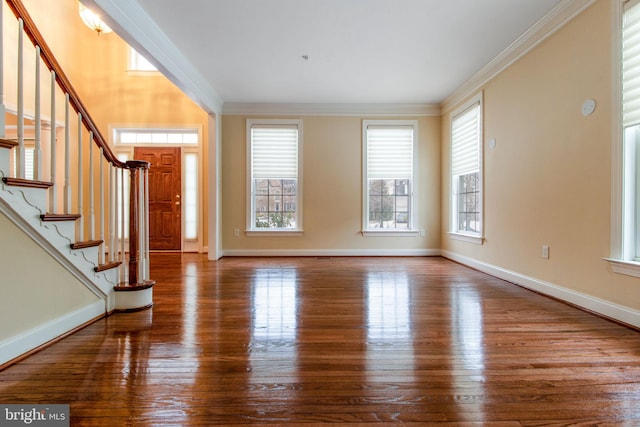 foyer with hardwood / wood-style flooring and crown molding