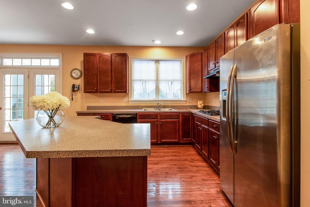 kitchen featuring hardwood / wood-style flooring, sink, and appliances with stainless steel finishes