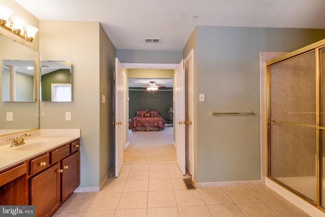 bathroom with ceiling fan, vanity, tile patterned flooring, and a shower with shower door