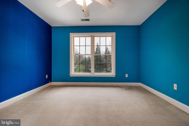 empty room featuring ceiling fan and carpet flooring