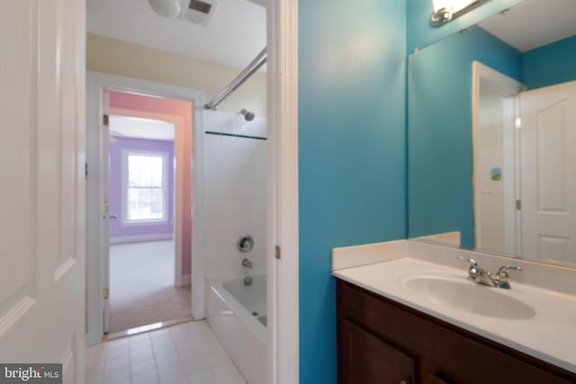 bathroom with vanity, tile patterned floors, and  shower combination