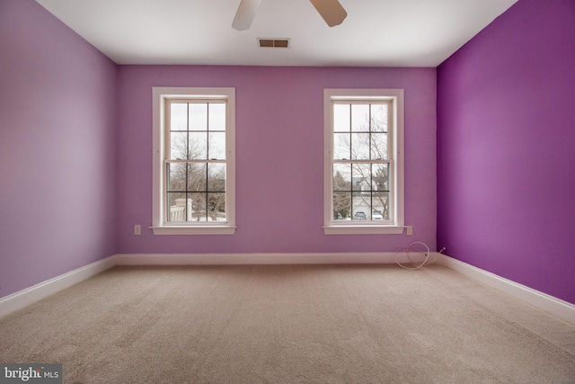 spare room with ceiling fan and carpet floors