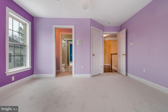 unfurnished bedroom featuring light carpet and ceiling fan