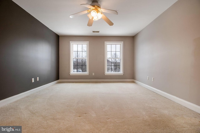 carpeted empty room featuring ceiling fan