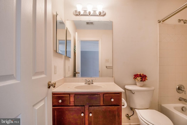 full bathroom with toilet, tiled shower / bath combo, and vanity