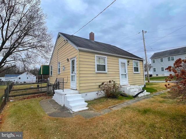 back of house with a lawn