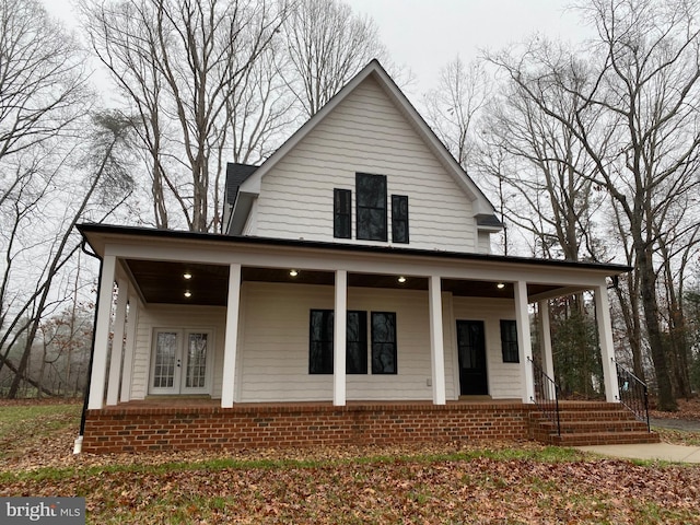 farmhouse inspired home with covered porch and french doors