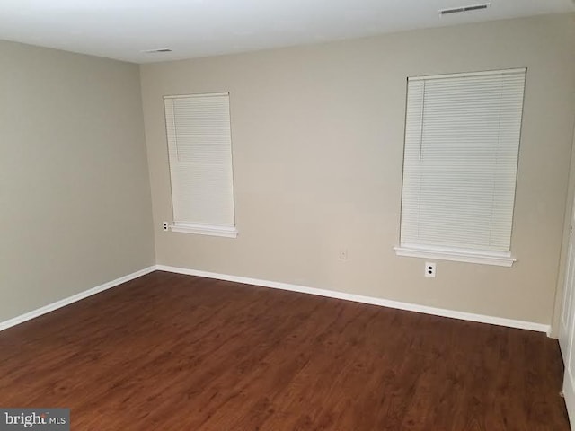 empty room featuring dark wood-type flooring