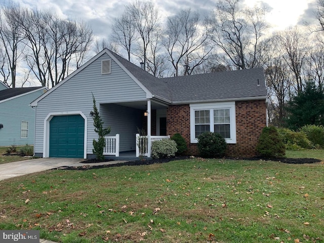 ranch-style house with covered porch, a front yard, and a garage