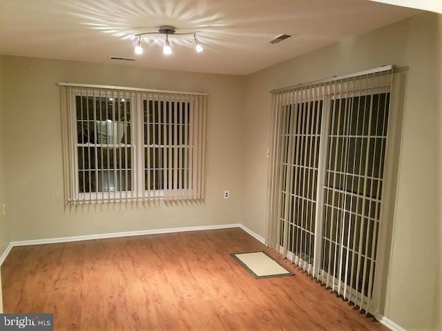 empty room with hardwood / wood-style flooring