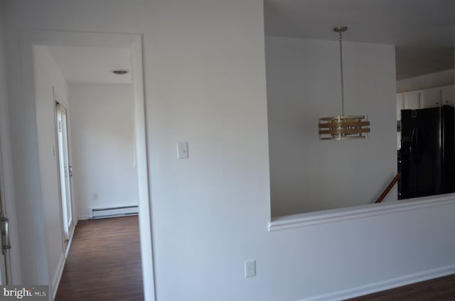 corridor with baseboard heating and dark wood-type flooring