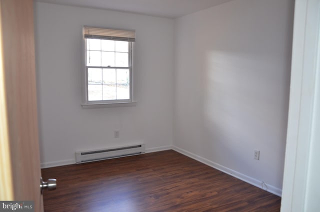 unfurnished room with a baseboard radiator and dark hardwood / wood-style floors