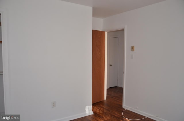 spare room featuring dark wood-type flooring