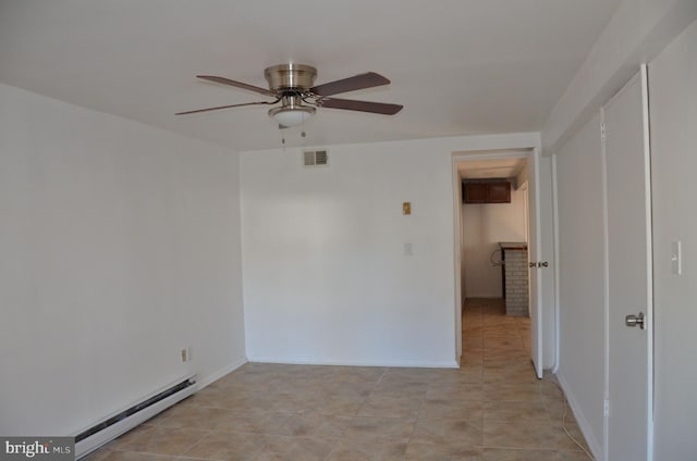 tiled spare room featuring ceiling fan and a baseboard radiator