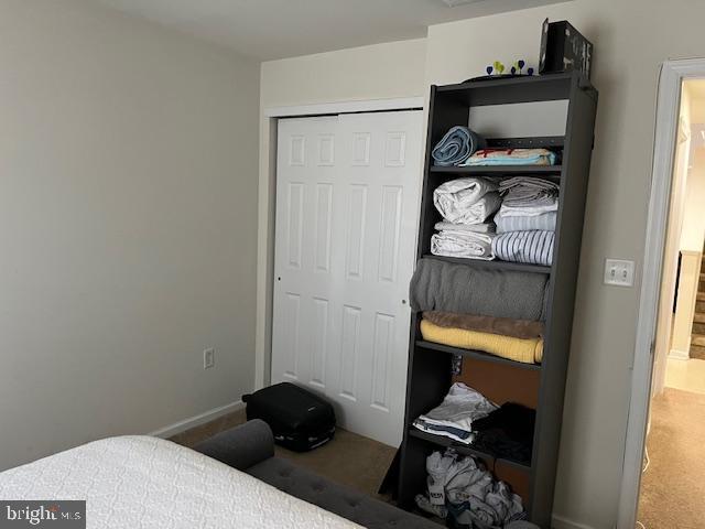 carpeted bedroom with a closet