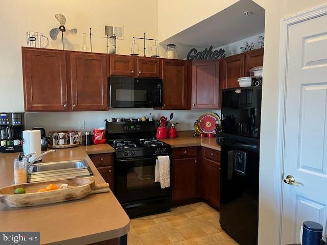 kitchen with sink and black appliances