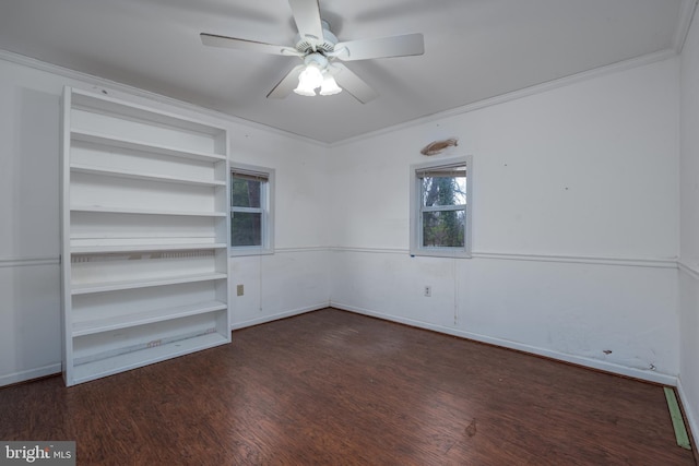 unfurnished room featuring dark hardwood / wood-style floors, ceiling fan, and crown molding