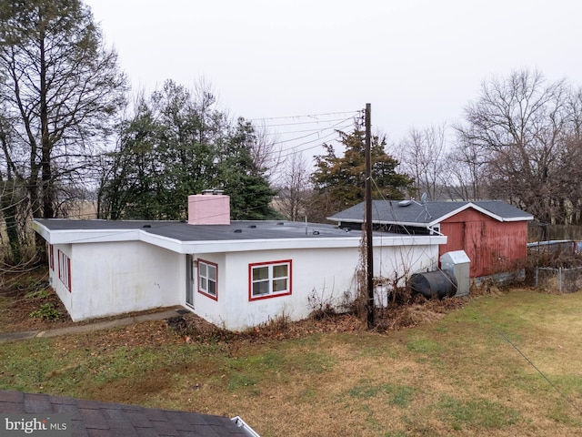 rear view of property featuring a lawn