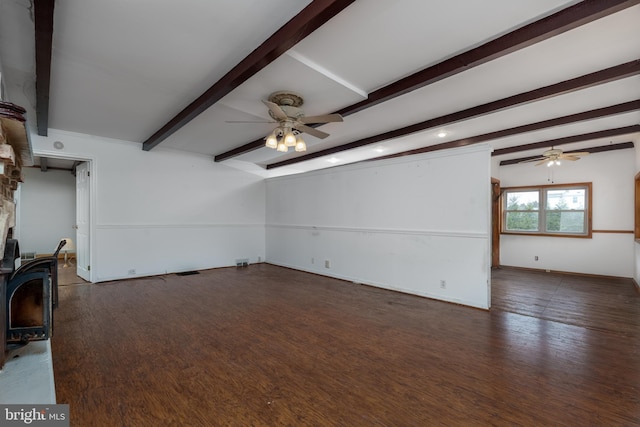 unfurnished living room featuring a stone fireplace, ceiling fan, beamed ceiling, and dark wood-type flooring