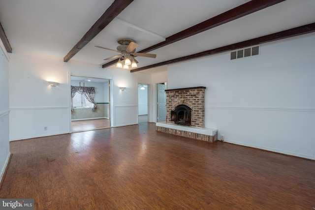 unfurnished living room with beamed ceiling, wood-type flooring, ceiling fan, and a fireplace