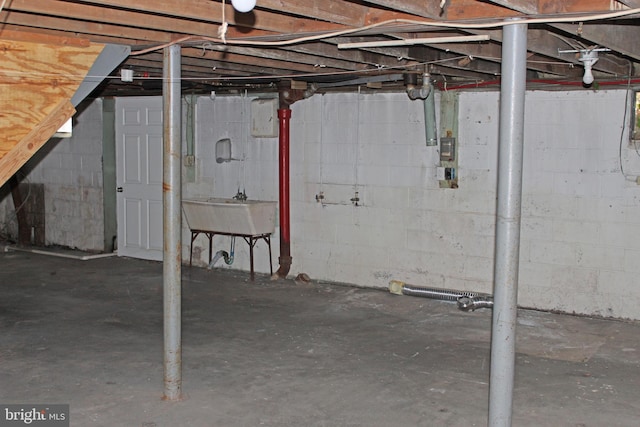 basement with electric panel and sink